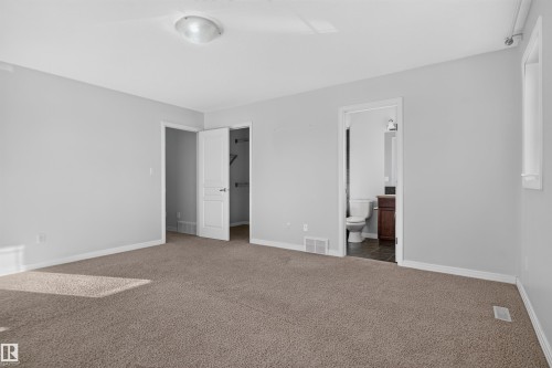 Light gray painted walls with brown carpet flooring - 2145 28 Street Nw, Edmonton, AB 