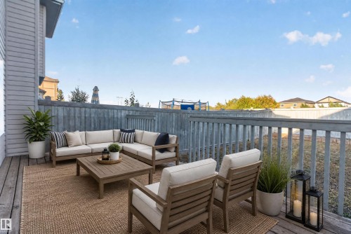 Expansive wood deck with a full-height privacy fence and painted railing - 2145 28 Street Nw, Edmonton, AB 