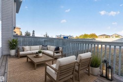 Expansive wood deck with a full-height privacy fence and painted railing - 