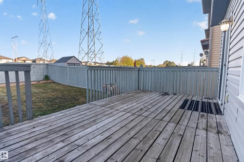 Outdoor wooden deck with perimeter railing, leading to a fenced yard with a detached shed - 2145 28 Street Nw, Edmonton, AB 