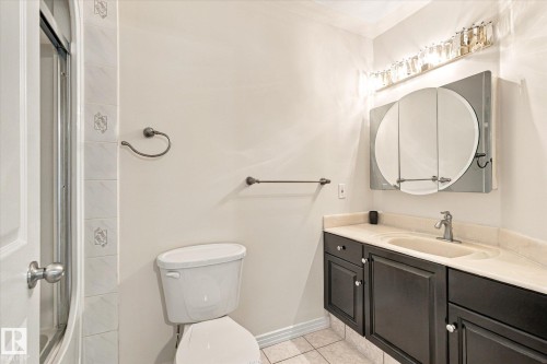 Vanity with integral sink, dark cabinetry, and light countertop - 771 Johns Road Nw, Edmonton, AB 
