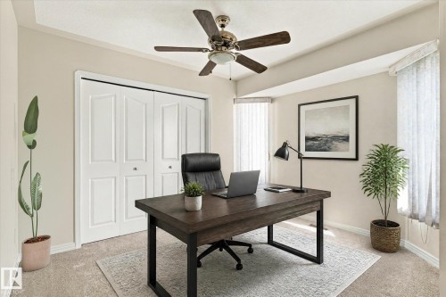 Neutral wall paint, carpet flooring, a ceiling fan, and white bi-fold closet doors - 771 Johns Road Nw, Edmonton, AB 