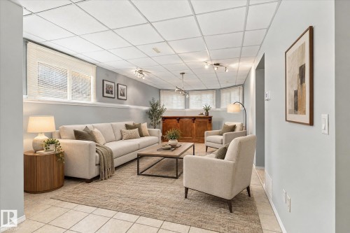 Recessed lighting fixtures illuminate the space, complemented by a drop ceiling - 771 Johns Road Nw, Edmonton, AB 