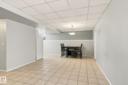 Tile flooring, drop ceiling, recessed lighting, and a pendant light fixture - 771 Johns Road Nw, Edmonton, AB 