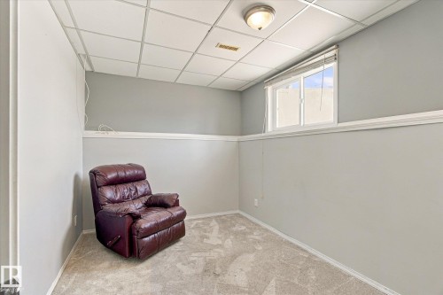 Recessed drop ceiling, flush-mount ceiling light, white trim, and a window with blinds - 771 Johns Road Nw, Edmonton, AB 