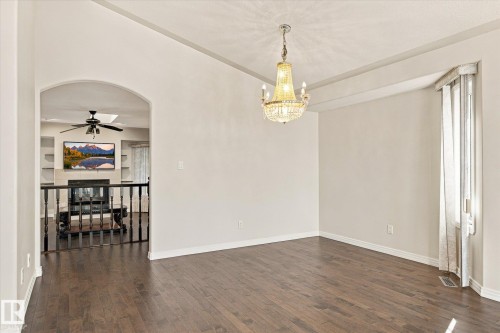 Dark wood-finish flooring with an arched entry - 771 Johns Road Nw, Edmonton, AB 