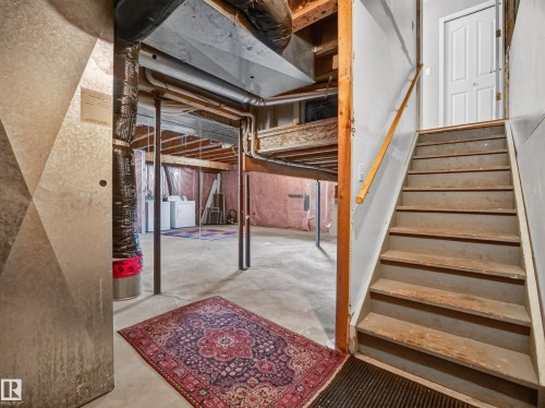 Concrete floor with exposed ceiling beams and structural supports - 14 Wells Court, Leduc, AB 