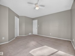 Spacious room with neutral wall tones and carpeted flooring - 