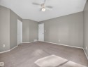 Spacious room with neutral wall tones and carpeted flooring - 14 Wells Court, Leduc, AB 