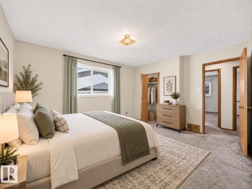 Recessed window, wood-finish interior doors, built-in open closet, ceiling-mounted light fixture, and textured carpeting - 14519 32 Street Nw, Edmonton, AB 