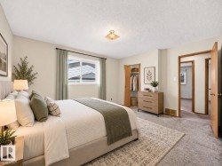 Recessed window, wood-finish interior doors, built-in open closet, ceiling-mounted light fixture, and textured carpeting - 