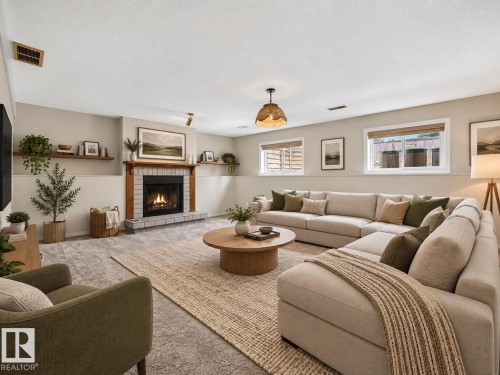 Fireplace with brick surround and wood mantel - 14519 32 Street Nw, Edmonton, AB 