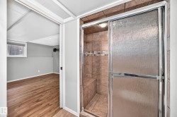 Tiled shower with sliding glass doors and a built-in bench - 