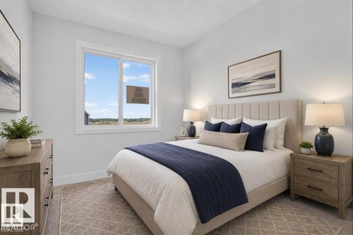Spacious room with a large window, light-toned walls, and wood-finish flooring - 101 Rosa Crescent, St. Albert, AB 