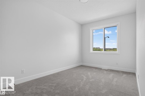 Carpeted flooring, white painted walls, white trim, and a window with a white frame - 101 Rosa Crescent, St. Albert, AB 