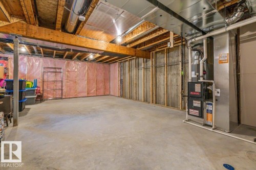 Unfinished basement with concrete flooring, exposed wood beam ceiling, and a visible HVAC system - 75 Garneau Gate, Spruce Grove, AB 