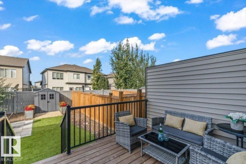 Private wood-finish deck with black metal railings - 75 Garneau Gate, Spruce Grove, AB 