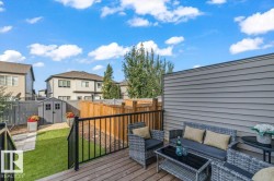 Private wood-finish deck with black metal railings - 