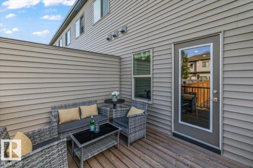 Private outdoor decking featuring durable siding, a full-light exterior door, and an operable window - 75 Garneau Gate, Spruce Grove, AB 