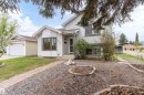 White siding exterior with a detached garage, bay window, and a brick paver pathway - 18739 72 Avenue Nw, Edmonton, AB 