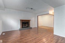 Brick fireplace with a wood mantel and stone hearth - 
