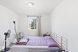 Recessed window with dark curtain rod, simple ceiling-mounted light fixture, and neutral wall tones - 