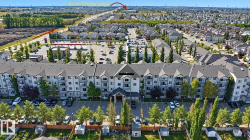 Multi-story building featuring multiple balconies, a structured roofline, and an integrated parking area - #224 3425 19 St Nw, Edmonton, AB 