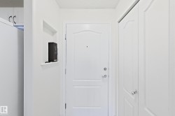 White entry door with decorative paneling and chrome hardware - 