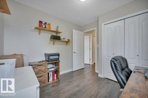 Vinyl plank flooring throughout, bright walls, and a convenient closet with bi-fold doors - 11448 169 Avenue Nw, Edmonton, AB 