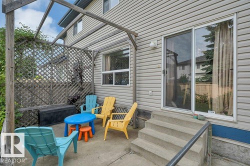Concrete patio with a wooden pergola, lattice privacy screening, and multi-pane windows - 11448 169 Avenue Nw, Edmonton, AB 