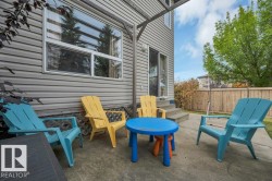 Concrete patio area with durable siding exterior, sliding glass door access, and a wood privacy fence - 