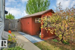 Storage shed with a pitched roof and a small deck area - 