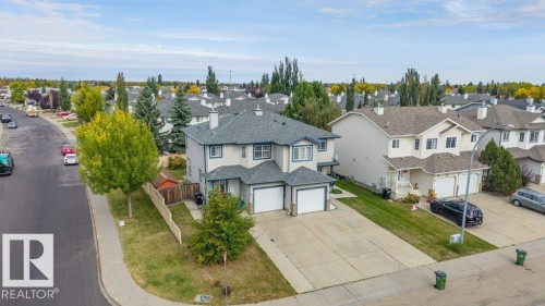 Two-story semi-detached residence with a dual garage, pitched roof, and concrete driveway - 11448 169 Avenue Nw, Edmonton, AB 