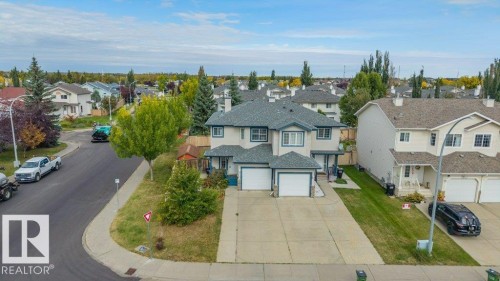 Two-story residence with a gray shingled roof, light-colored siding, and attached two-car garage - 11448 169 Avenue Nw, Edmonton, AB 