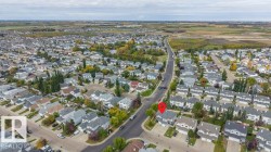 Residential neighborhood setting with mature trees and paved roadways - 