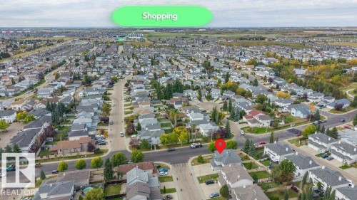 Aerial perspective showcasing a residential neighborhood with detached homes, mature trees, and paved streets - 11448 169 Avenue Nw, Edmonton, AB 