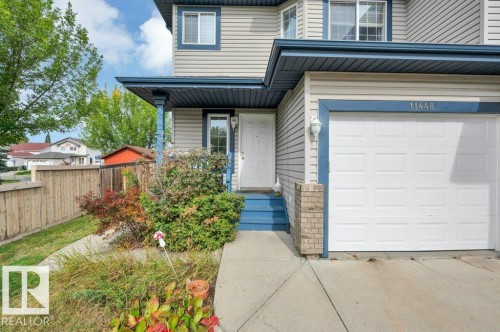 Light-colored siding exterior with blue trim accents - 11448 169 Avenue Nw, Edmonton, AB 