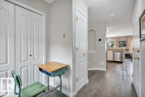 Vinyl plank flooring throughout, bright white trim, and a decorative wall niche - 11448 169 Avenue Nw, Edmonton, AB 
