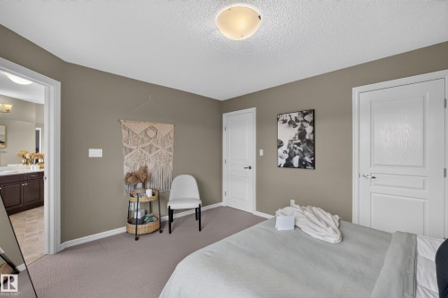 Neutral-toned interior featuring wall-to-wall carpeting, two-panel interior doors with lever-style hardware, and a flush-mount dome light fixture - 7 Bremner, Fort Saskatchewan, AB 