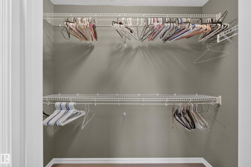 Walk-in closet featuring dual-level white wire shelving - 7 Bremner, Fort Saskatchewan, AB 