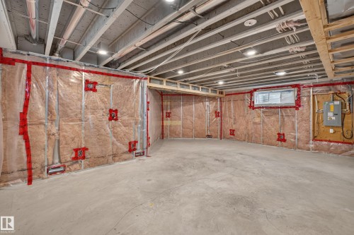 Unfinished space featuring exposed structural joists, concrete flooring, recessed lighting, wall insulation, and a singular window - 7 Bremner, Fort Saskatchewan, AB 