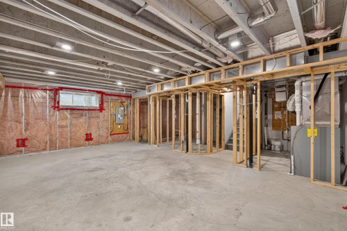 Unfinished utility space featuring exposed wood-stud framing, concrete flooring, recessed lighting, and exposed ceiling joists - 7 Bremner, Fort Saskatchewan, AB 