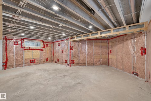Unfinished lower level featuring concrete flooring, exposed ceiling joists, recessed lighting, and perimeter wall insulation with vapor barrier - 7 Bremner, Fort Saskatchewan, AB 