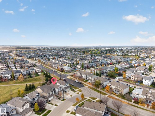 Aerial perspective of a detached residential property featuring a shingled roof, an attached front-facing garage, and a paved driveway, situated on a corner lot - 7 Bremner, Fort Saskatchewan, AB 