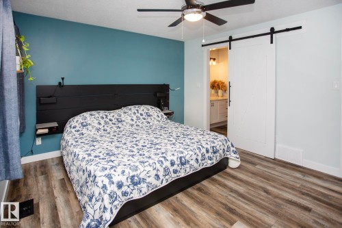 Wood-finish flooring with a ceiling fan and contemporary lighting - 8 Ash Crescent, St. Albert, AB 