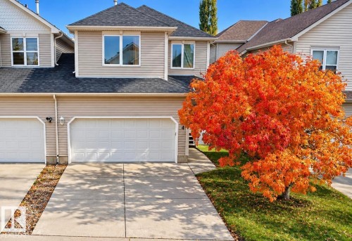 Multi-level residence featuring vinyl siding, an asphalt shingle roof, a two-car garage, and a concrete driveway - 4 1920 Millwoods Rd E Nw, Edmonton, AB 