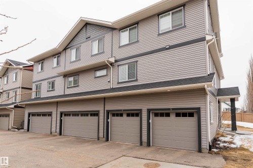 Multi-level exterior with horizontal siding and dark trim accents - 6 12815 Cumber Nw, Edmonton, AB 