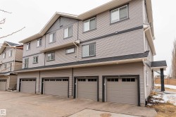 Multi-level exterior with horizontal siding and dark trim accents - 