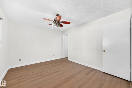 Wood-finish flooring, white walls, ceiling fan, and white trim - 3924 26A Avenue Nw, Edmonton, AB 