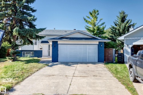 Two-story residence featuring a two-car garage, concrete driveway, and mature landscaping - 3924 26A Avenue Nw, Edmonton, AB 